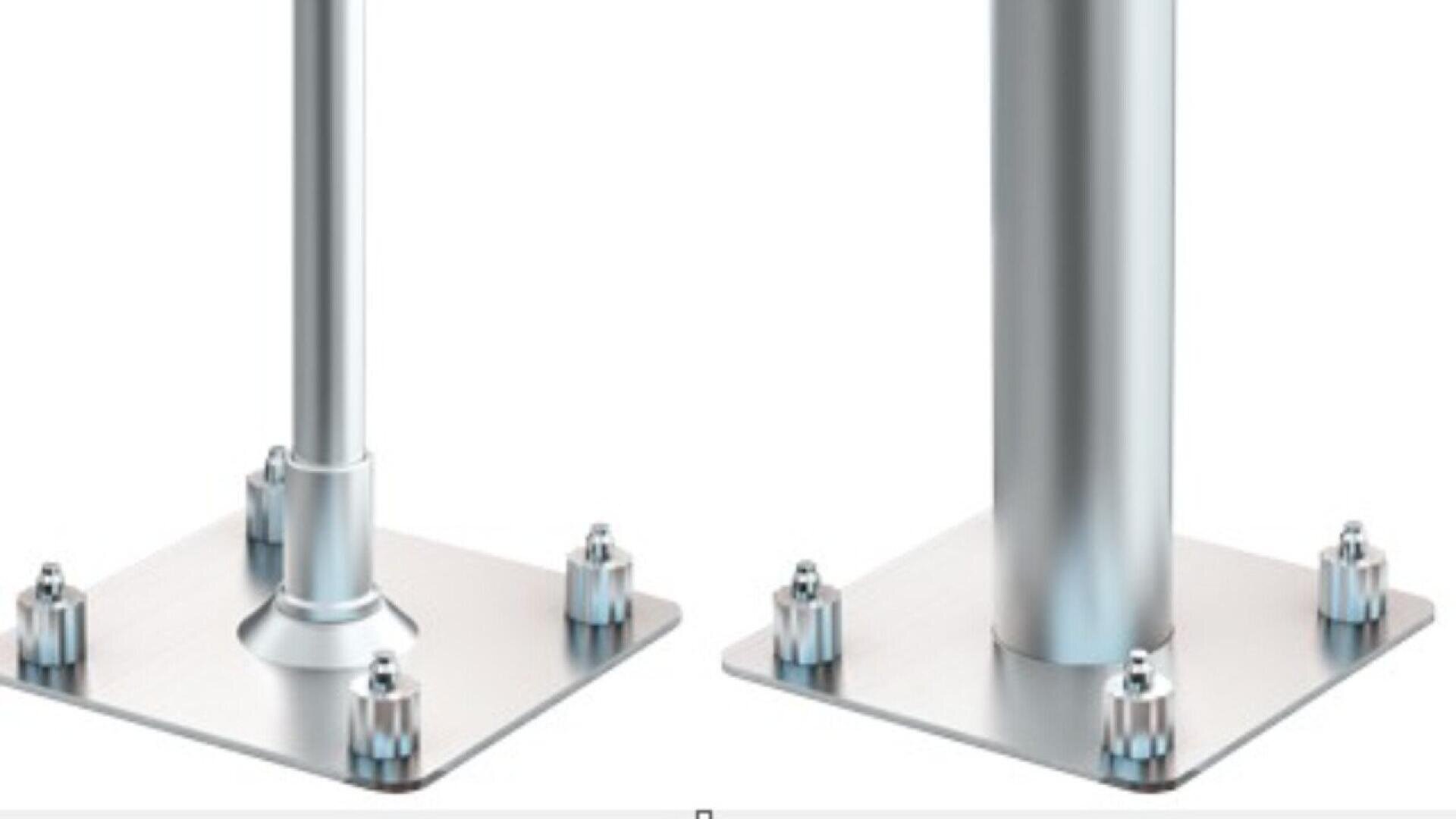Two metal poles, each mounted vertically on a square metal base plate with four bolts at the corners. The pole on the left has a tapered connection to the base, while the pole on the right has a straight connection.