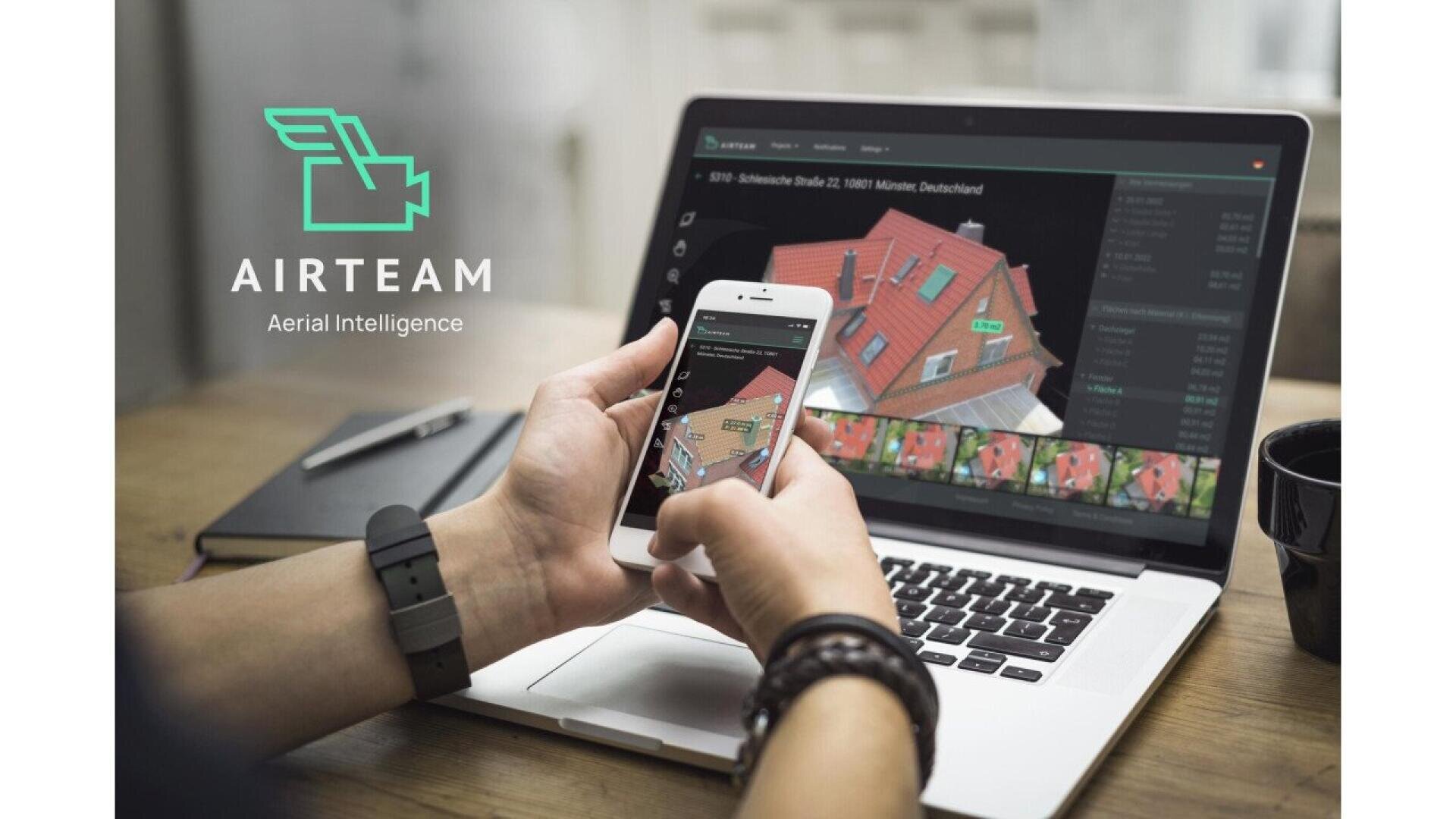 A person uses a smartphone and laptop, both displaying a 3D aerial view of a red-roofed house. The screen shows detailed measurements. The AIRTEAM Aerial Intelligence logo is visible on the left.