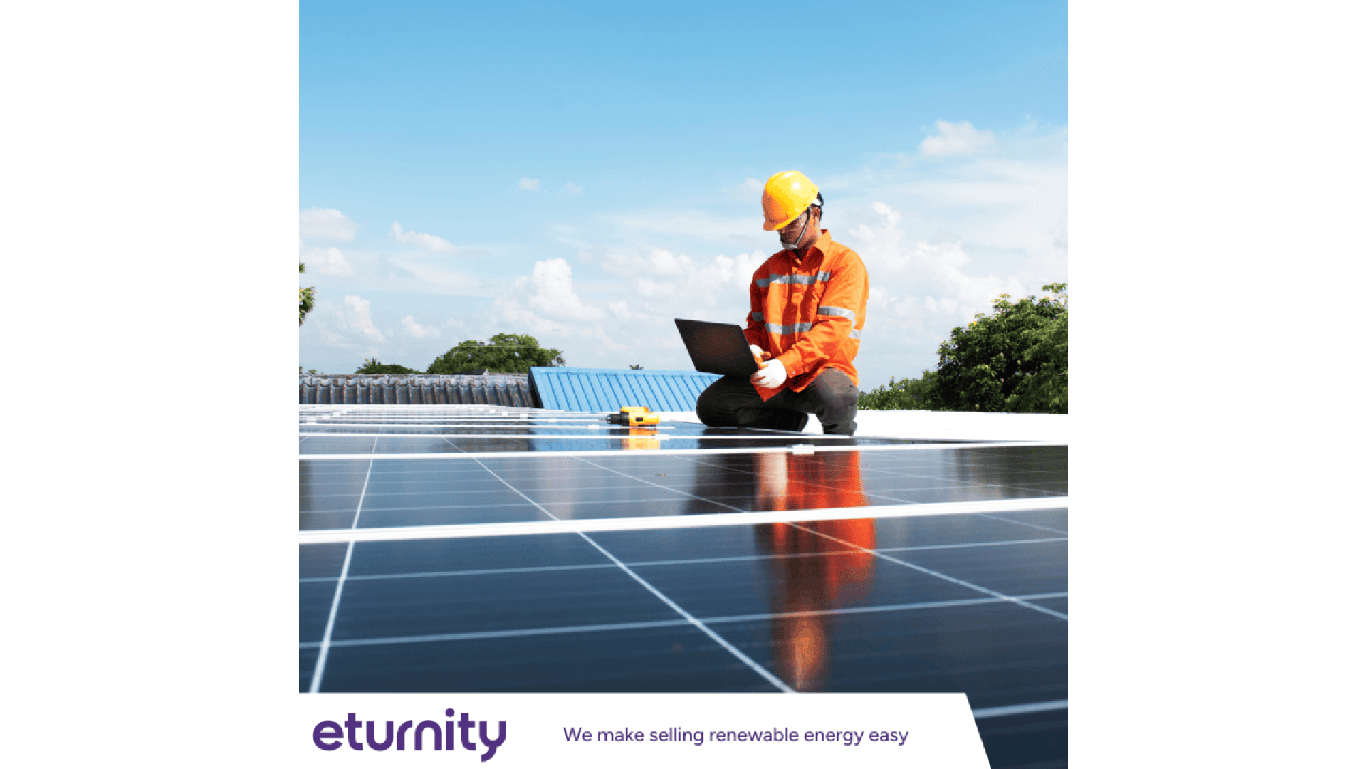 A worker in an orange safety jacket and helmet kneels on solar panels while using a laptop. The scene is outdoors with trees and a blue sky in the background. The text below reads “eturnity – We make selling renewable energy easy.”.