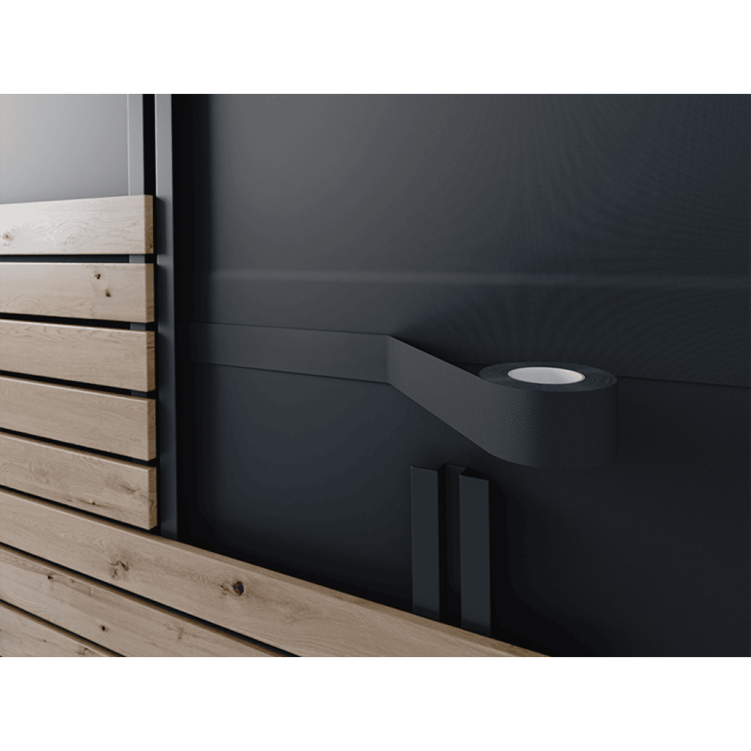 A black roll of adhesive tape is mounted on a dark wall next to horizontal wooden panels, creating a modern, minimalistic look.